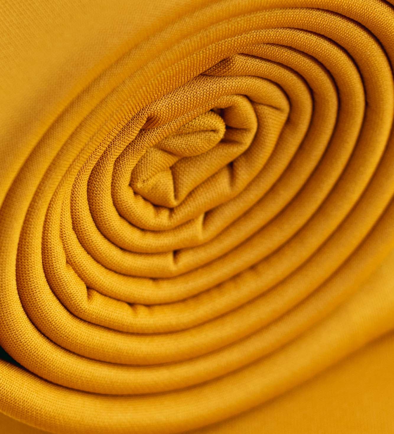 Artistic folds in mustard fabric