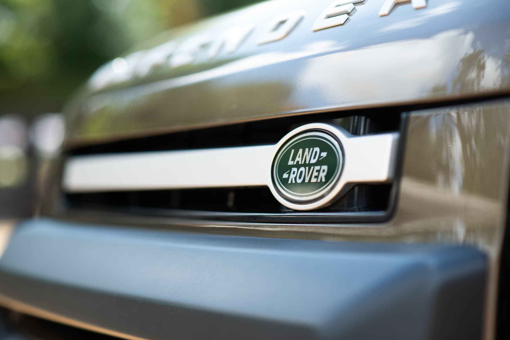 Close-up of the Land Rover badge on the Defender's front grille