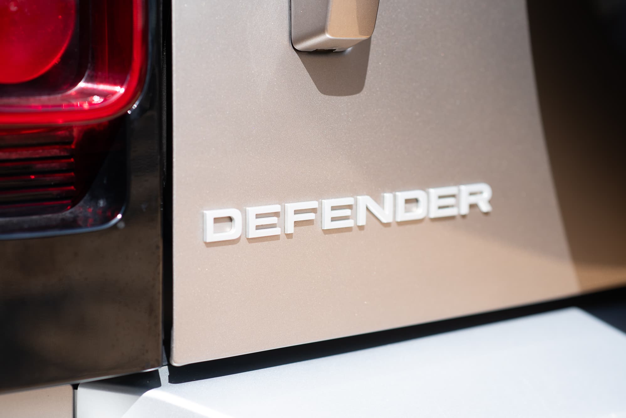 Defender badge and rear light detail on a Land Rover Defender