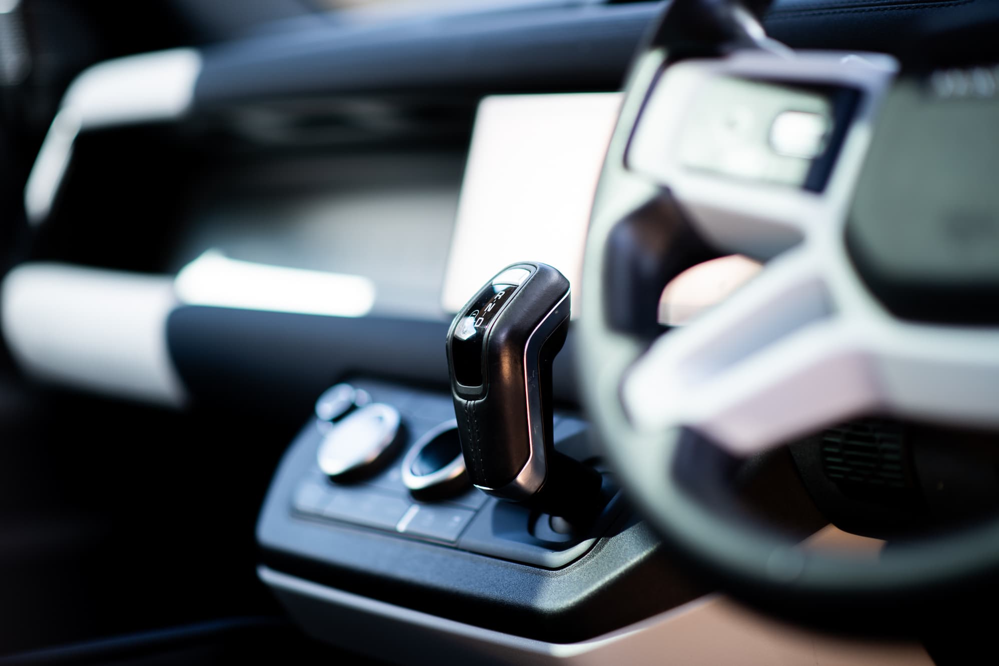 Land Rover Defender interior showing the gear selector and steering wheel