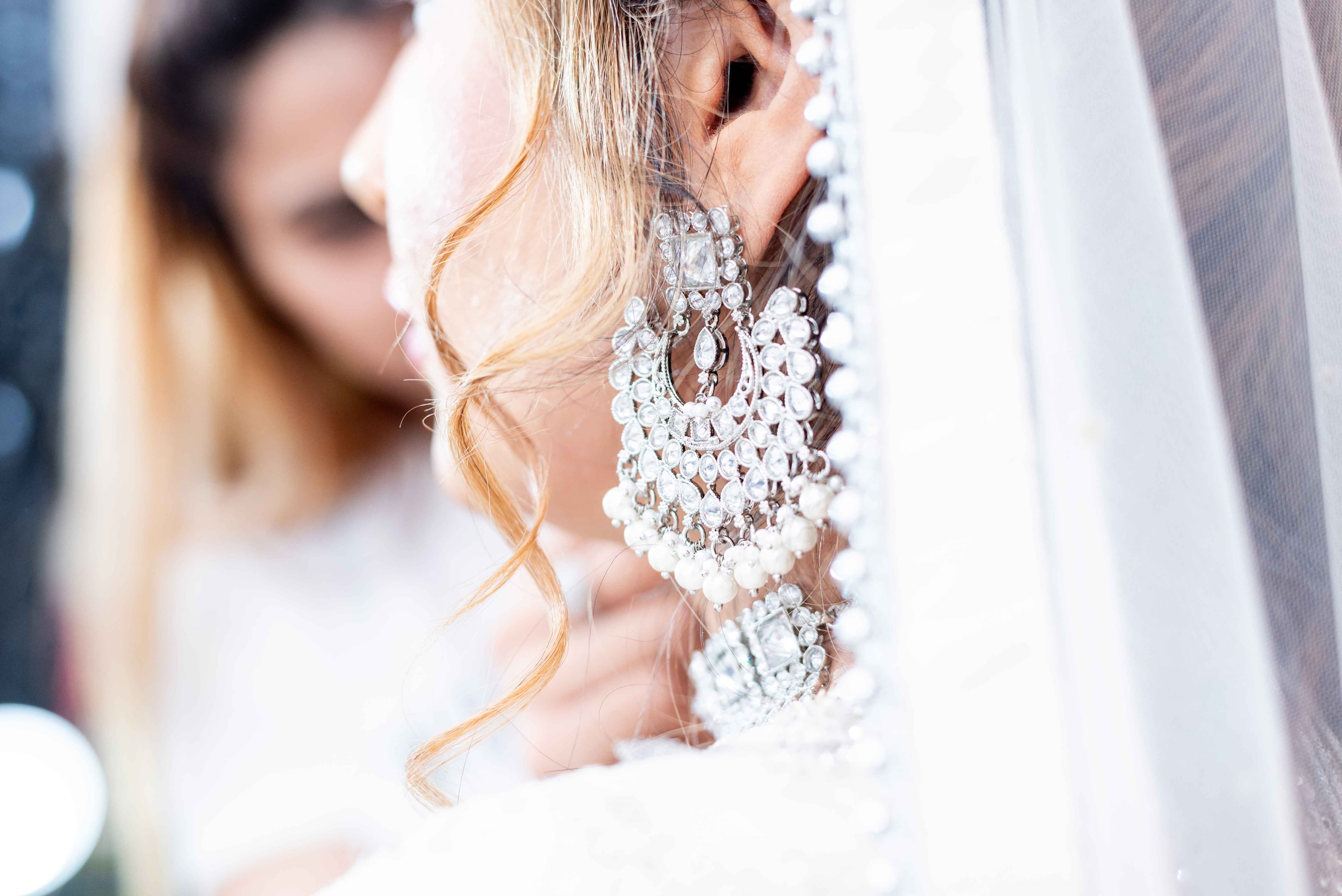 Bride's reflection in the mirror as she prepares for her wedding