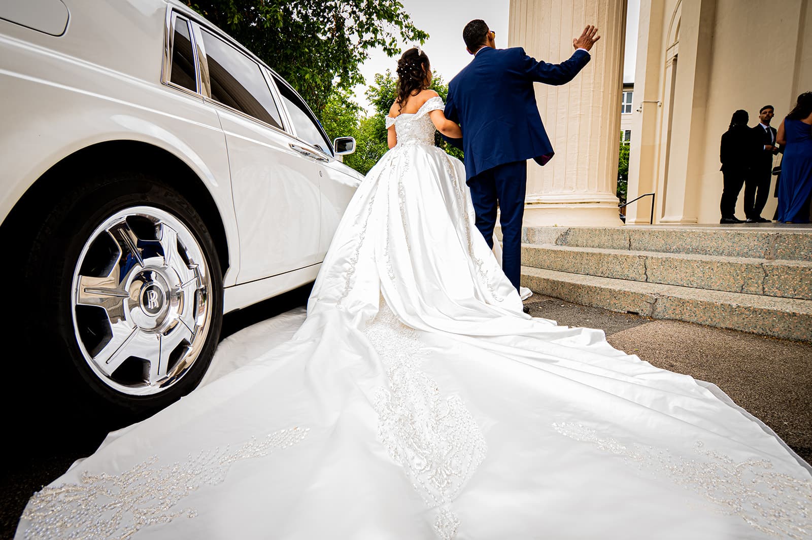 The bride's father walks her to the church entrance