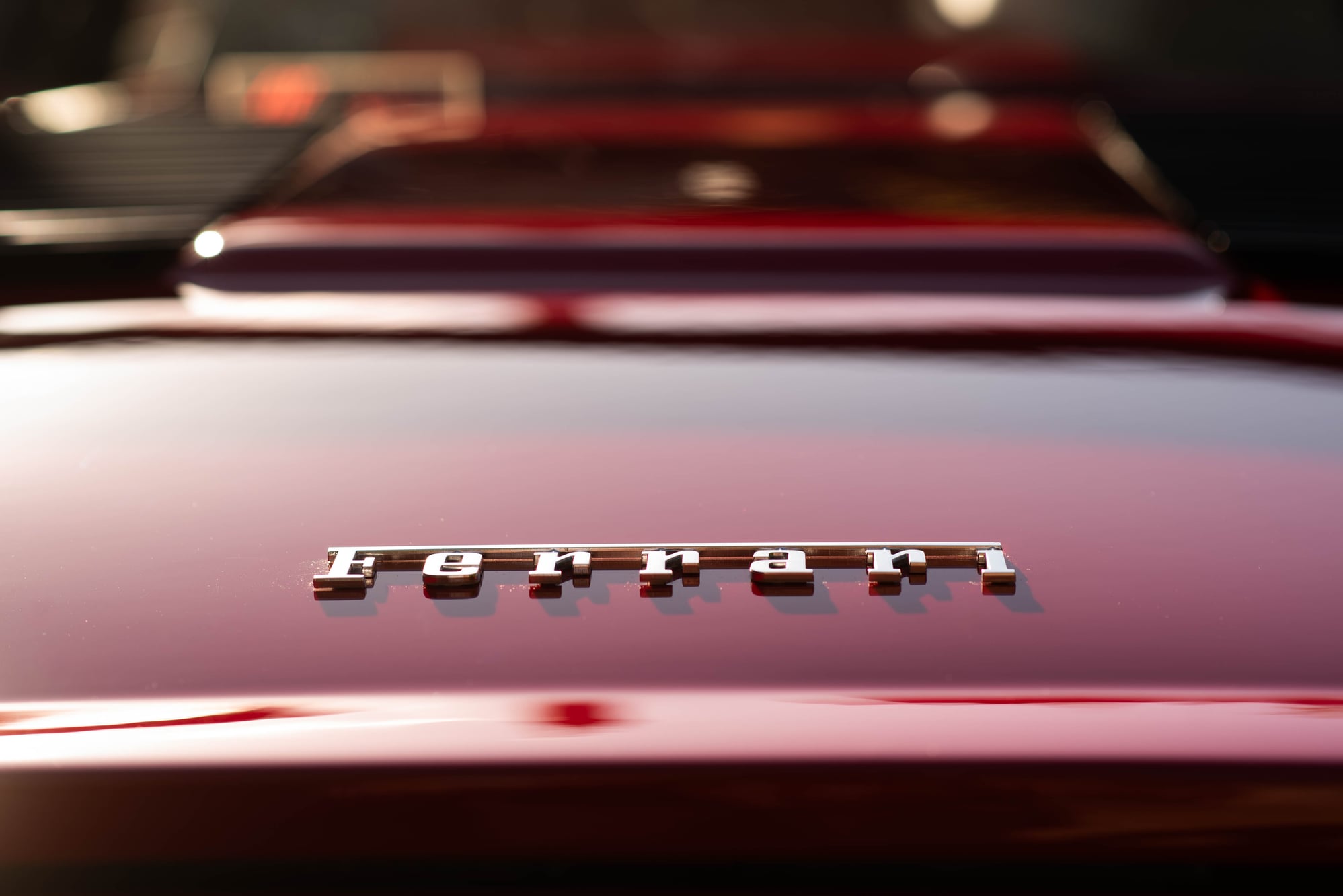 Chrome Ferrari script on the rear deck of a red 308